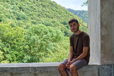 a sitted caucasian boy looking at camera. High quality photo