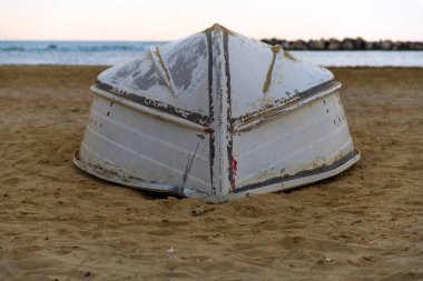 the keel of a small boat capsized on the beach. High quality photo