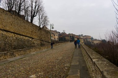 Bergamo, Italy - 15 jan 2023: the cobbled climb towards Porta San Lorenzo. High quality photo clipart