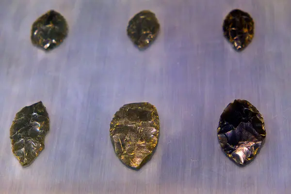 Karanlık arka planda neolitik obsidiyen ok ucu. Yüksek kalite fotoğraf
