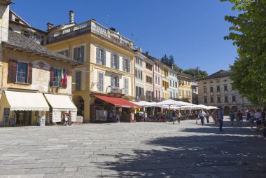 Lago DOrta, İtalya - 21 Ağustos 2022: Orta San Giulio 'nun tarihi merkezindeki insanlar ve eski binalar. Yüksek kalite fotoğraf