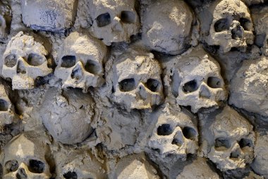 Wall of human skulls and bones. High quality photo clipart