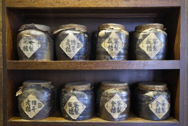 traditional chinese ceramic jars for medicine on wooden shelf. High quality photo clipart