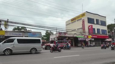 Zamboanga, Filipinler - 20 Ağustos 2024: caddeden geçen cip otobüsleri. Jeepney ve trycicle Filipinler 'de benzersiz popüler bir ulaşım biçimidir..