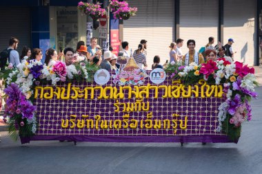 Chiang Mai, Thailand - February 4, 2023: Beautiful colorful Chiang Mai Flower Festival 2023 Parade on the old town street with fresh flowers decorated cars and people in traditional costumes.