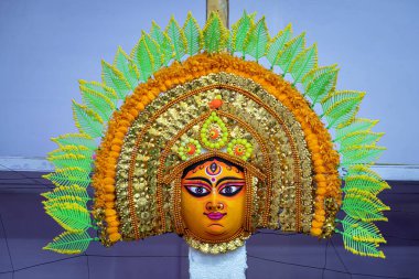 Beautiful handmade Chhau mask for classical dance displayed in a shop for sale in blurred background. Indian art, culture, tradition and handicraft.