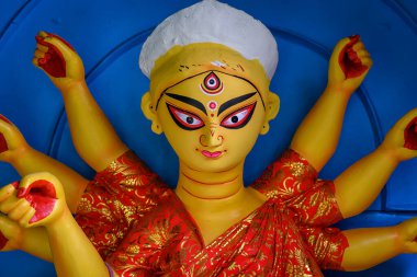 Clay idol of Goddess Devi Durga is in preparation for the upcoming Durga Puja festival at a pottery studio in Kolkata, West Bengal, India clipart