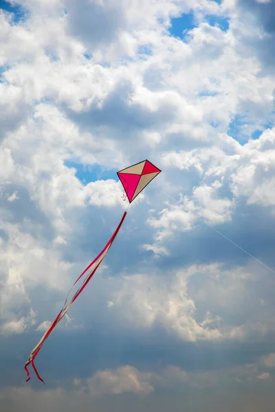Kites flying in blue and cloudy sky, kite festival. Kite flying in the wind in a sunny day in sky