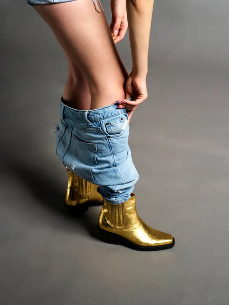 Blauwe Jeans Geïsoleerd Grijze Achtergrond Met Gouden Bladschoenen Droeg Vrouw — Stockfoto