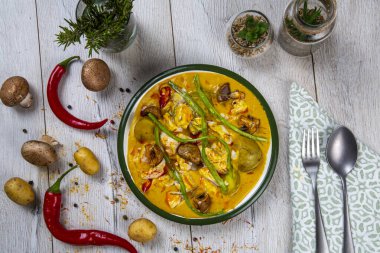 thai spicy soup with chicken, vegetables and spices