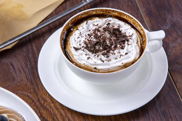Coffee covered with cream and grated chocolate. Cappuccino