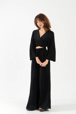 Siyah çan kollu modern genç kadın geniş paça pantolonlu, moda görünümlü..