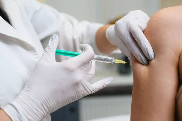 Doctor apply syringe needle in female hand, health vaccination and medical treatment concept