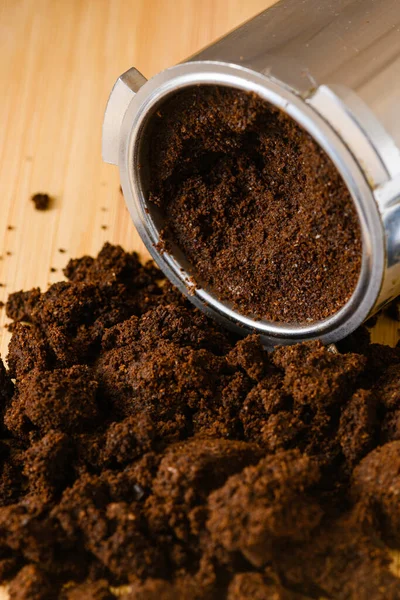 Spent or used coffee grounds with portafilter. Used grounded coffee