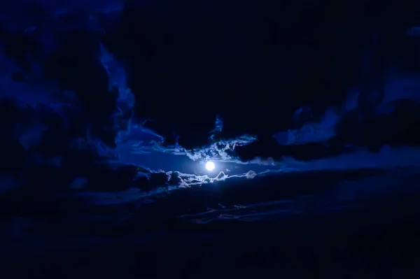 View of the moon in the clouds in the night sky