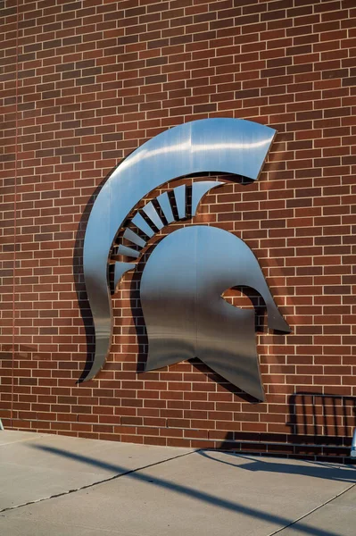 stock image East Lansing MI - October 29, 2022: Metal symbol of Spartans in front of the entrance to the Breslin Center at Michigan State University