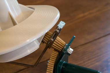 Örgü örmede kullanılan mekanik iplik ya da makara. Yakın çekim, dişli mekanizması, seçici odaklanma. Yüksek kalite fotoğraf