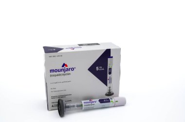 POTTERVILLE, MI - JANUARY 14, 2024: Mounjaro tirzepatide prescription box with injection pen isolated on a white background. High quality photo clipart