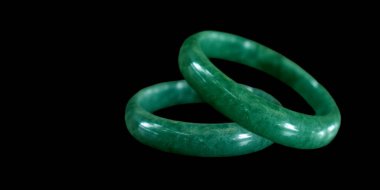 Jade is a gold necklace embellished with green jade.