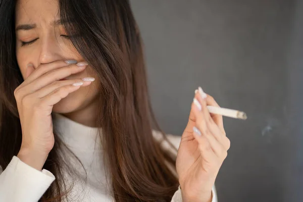 stock image closeup Asian woman coughing from smoking cigarette.