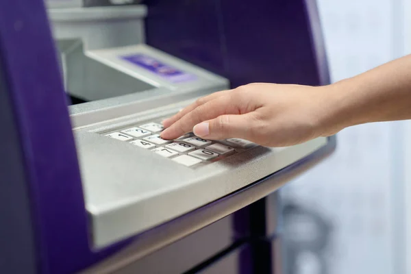 stock image woman hand entering personal identification number on ATM.