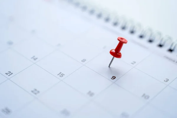 Calendar with red pins on the 9th, mark the date of the event with a pin.