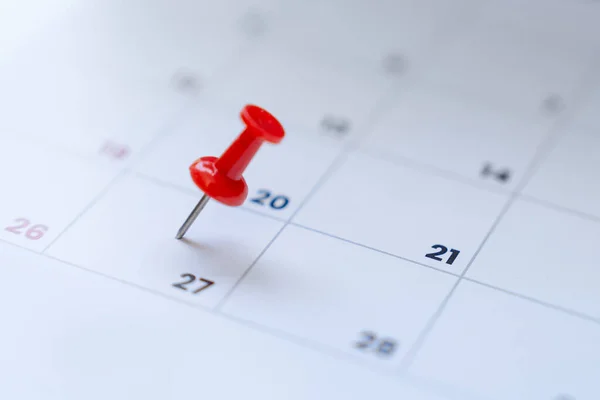 stock image Embroidered red pins on a calendar event or travel planning concept.