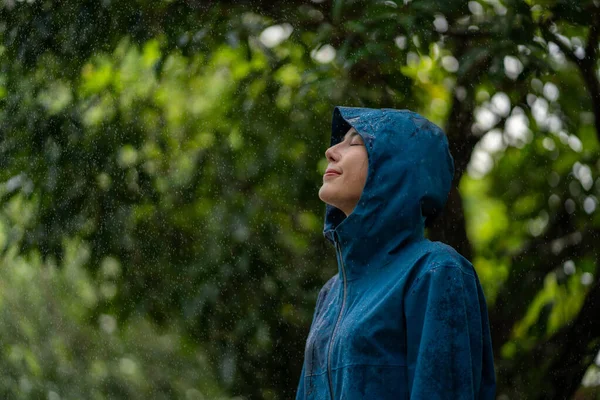 stock image Happy woman standing in rain.  Rainy season.