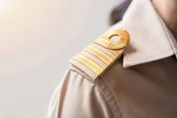 stock image Photo of a brown uniform with a gold stripe on the shoulder, Thai civil servant uniform.