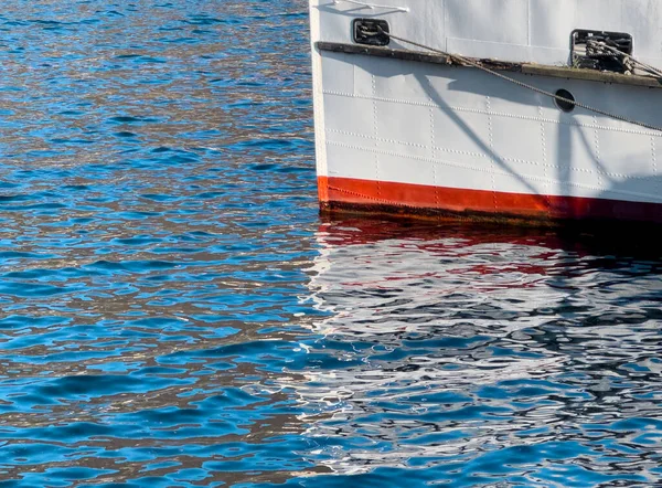 Detail of boat on blue water.