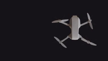 Top view of a flying drone with rotating propellers on a black background with an empty place to insert. Looped animation..