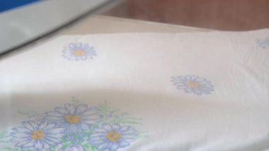 Close-up of a hot iron steaming while ironing..