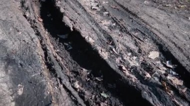 Rough terrain, a track from a vehicle's wheel on a dirt road. A track from a car that got stuck in the mud.