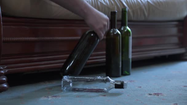 醉汉躺在沙发上 手里拿着酒瓶 酗酒和酗酒的问题 — 图库视频影像