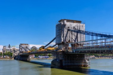 Budapest, Hungary - July 04, 2022: Repair of the Szechenyi Chain Bridge over the Danube River in Budapest. It is the oldest and most famous road bridge in Budapest.