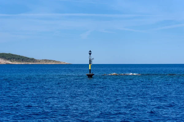 stock image Lighthouse on sea. Traffic sign in the sea