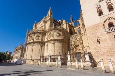 Seville, Spain - August 01, 2024: Sevilla Cathedral (Catedral de Santa Maria de la Sede), Gothic style architecture in Spain, Andalusia. Historic buildings and monuments of Seville, Spain. clipart