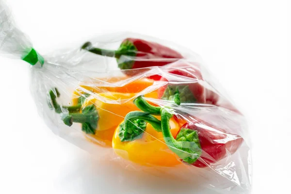 stock image Sack of red and yellow fresh bell peppers on a white background