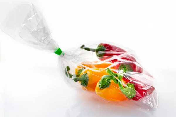 stock image Sack of red and yellow fresh bell peppers on a white background