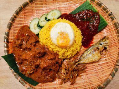 fried fish and egg with rice and vegetables Nasi goreng