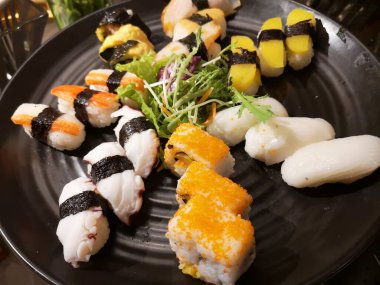 Top view of delicious sushi on slate boards