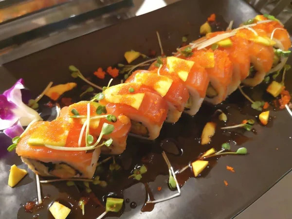 Top view of delicious sushi on slate boards and chopsticks