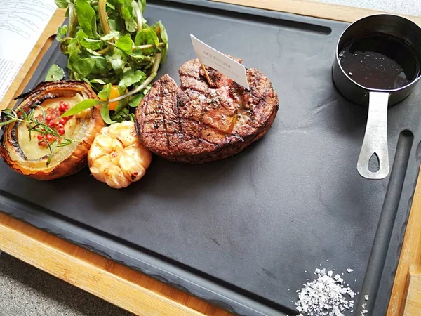 Delicious grilled steak on black board