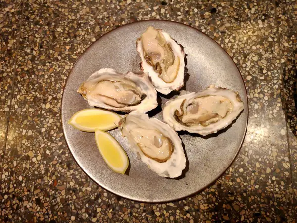 raw oysters on a stone plate