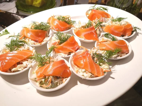 Smoked salmon in small plates apetizers with dill