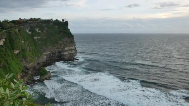 バリ島 インドネシア 1月22 2018 美しいインド洋の波と緑のウルワツ寺院の崖夜 4Kワイドショット — ストック動画