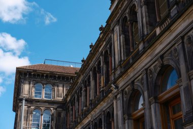 EDINBURGH - JULY 28, 2024: Intricate architecture of the National Museum of Scotland in Edinburgh under a clear blue sky. clipart