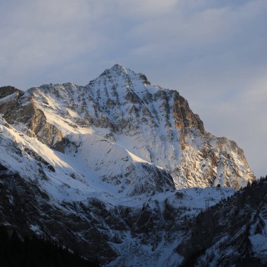 Sun lit peak of Mount Arpelistock, Switzerland.