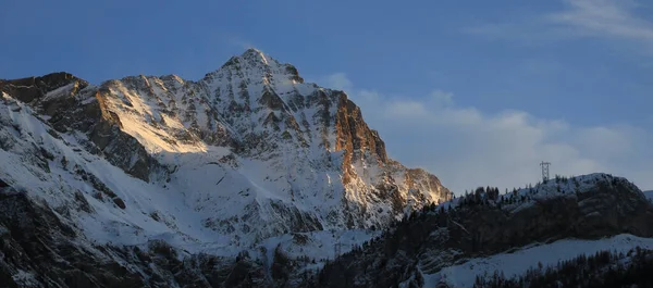 Sun lit peak of Mount Arpelistock, Switzerland.