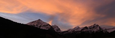 Bright lit clouds over mountains near Gstaad, Switzerland.